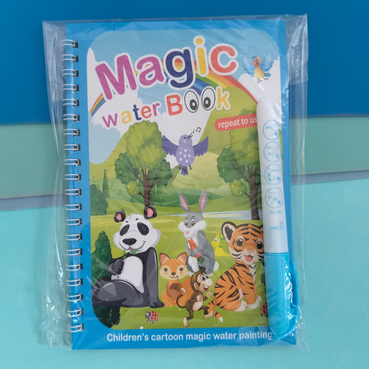 Children's magic water book with cartoon animals and a pen on a blue background